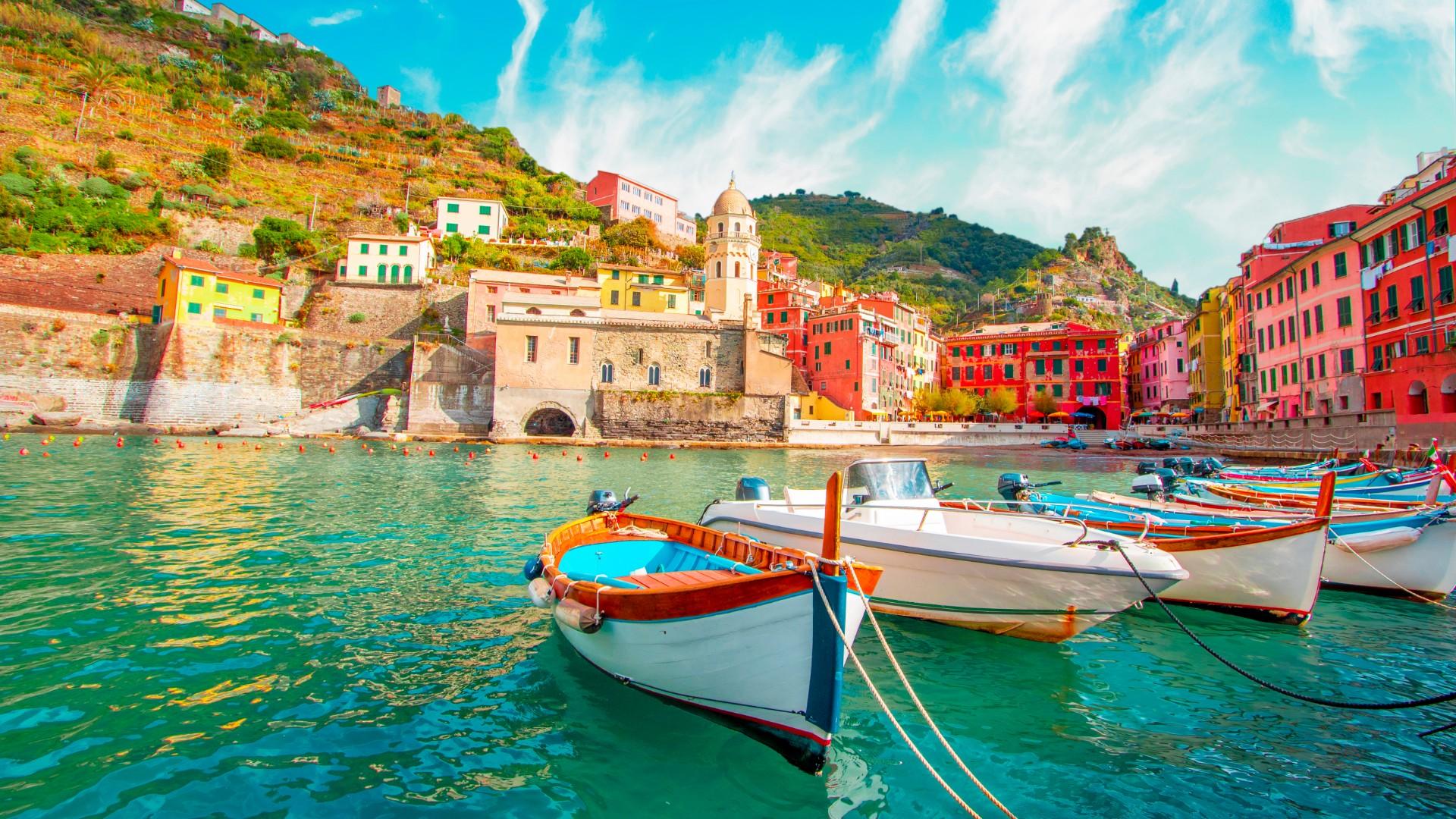 Colorful houses and boats in a picturesque coastal village.